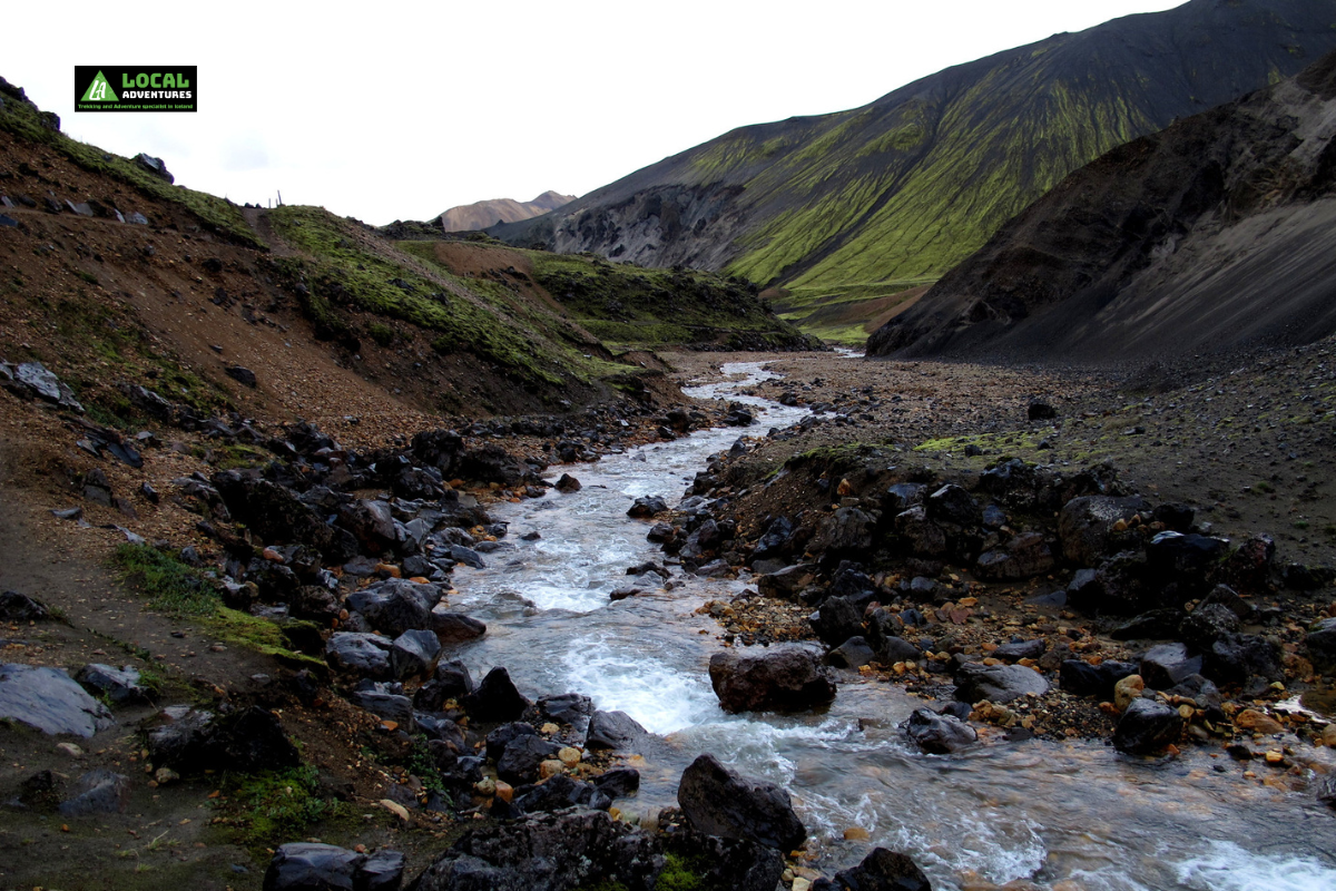 A narrow stream flows through the rocky <yoastmark class=